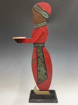 Lot 120 - A figural painted wood dumb waiter. Height 77cm.