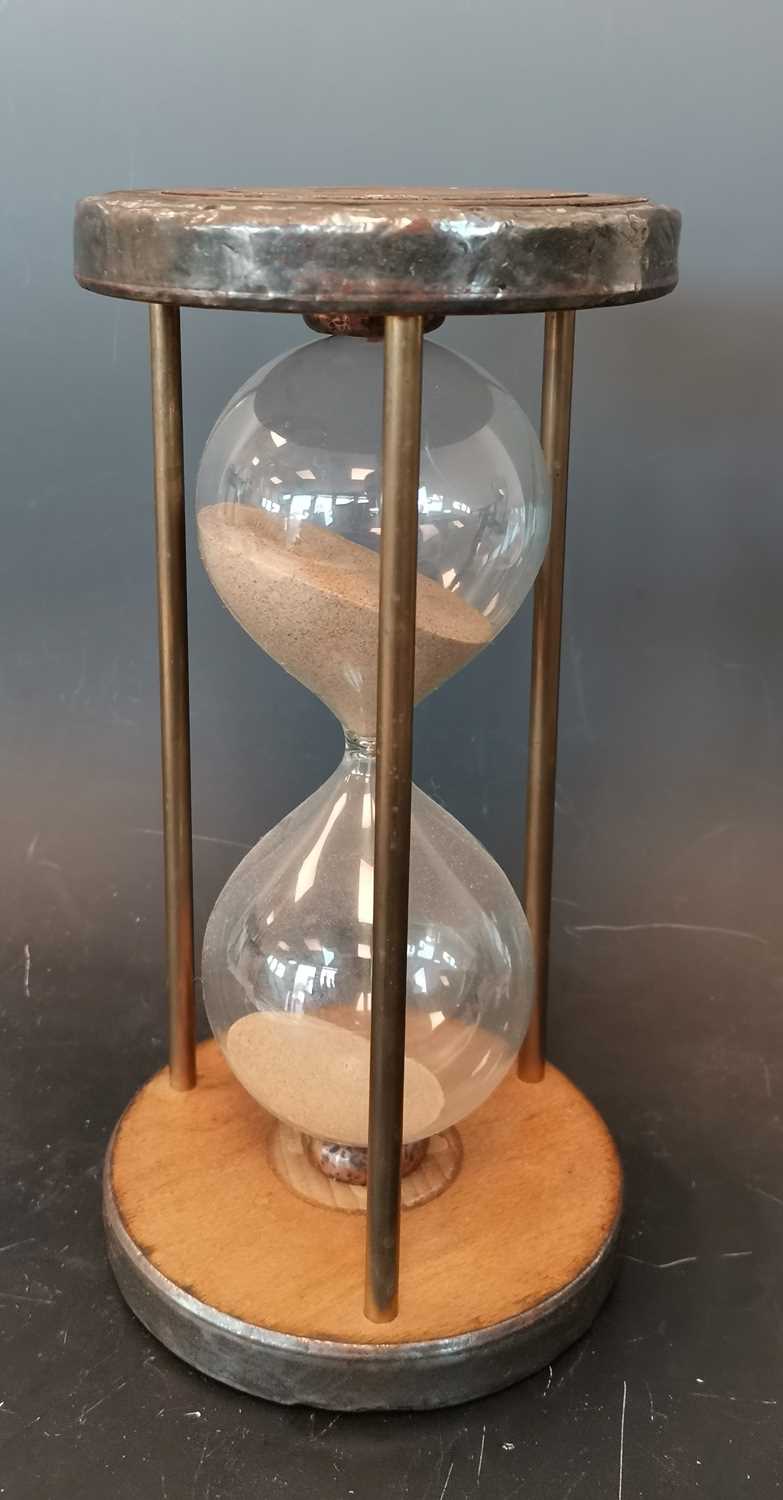 Lot 17 - An antique sand timer with pewter collars.