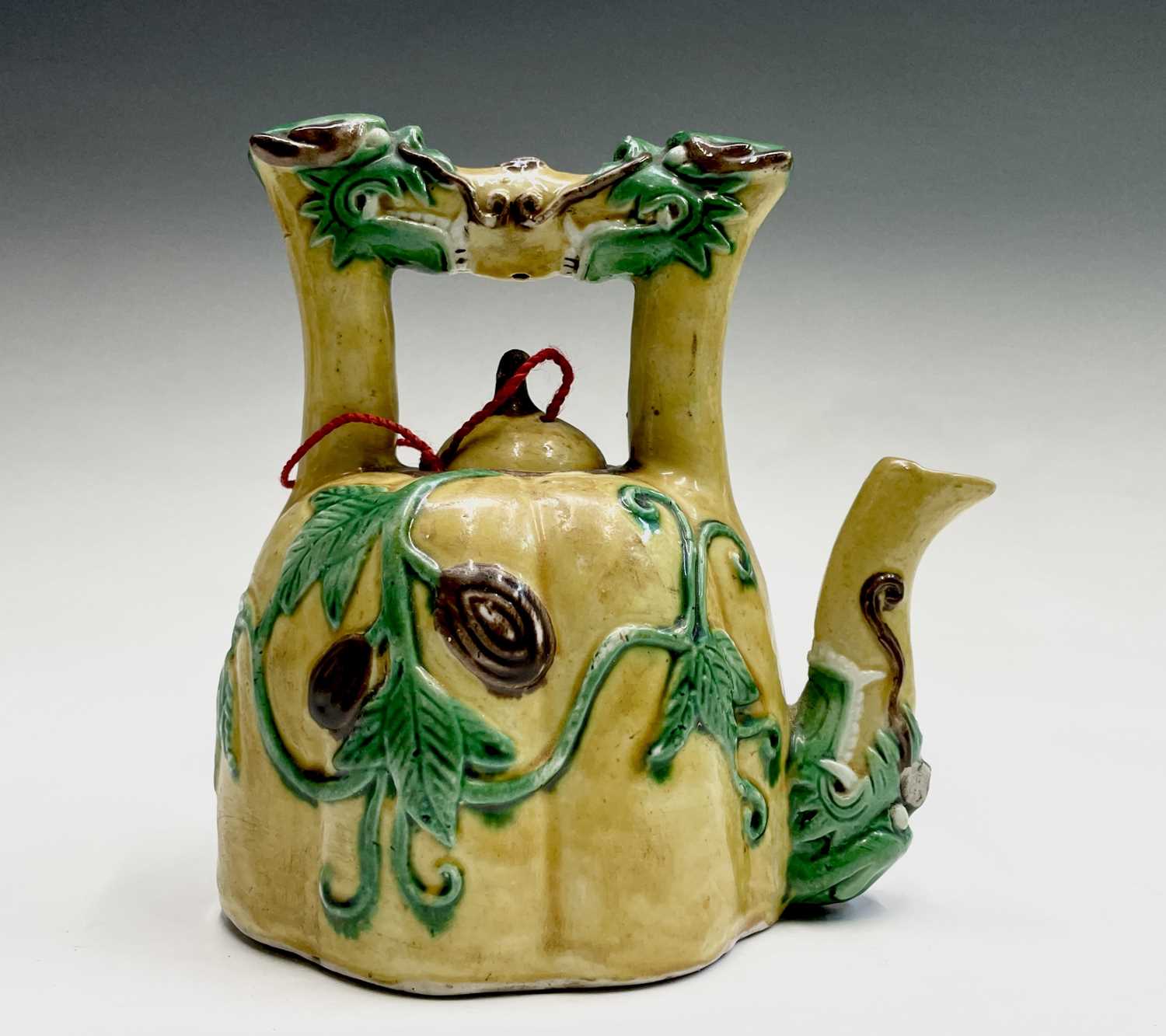 Lot 26 - A Chinese sancai-glazed teapot, the spout and...