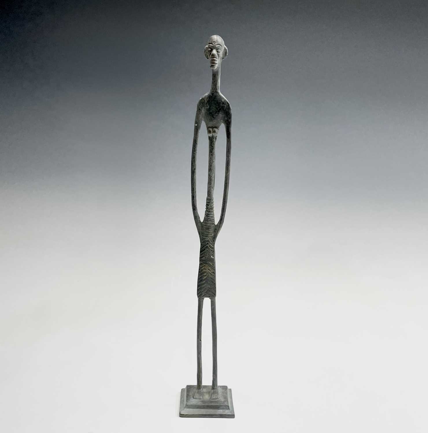 Lot 209 - An African bronze figure of elongated form,...