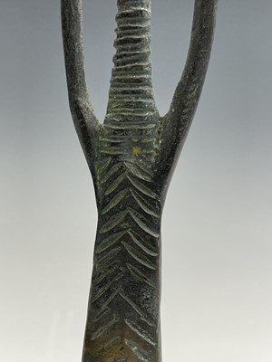 Lot 209 - An African bronze figure of elongated form,...
