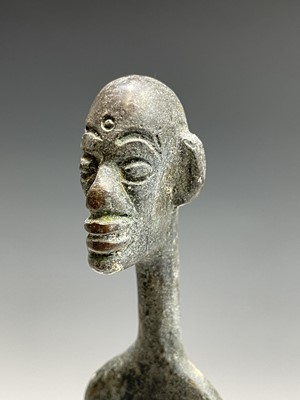 Lot 209 - An African bronze figure of elongated form,...