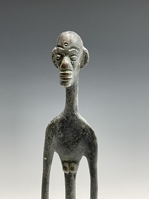 Lot 209 - An African bronze figure of elongated form,...