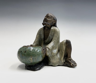 Lot 199 - A Chinese Ge-type figure of a seated luohan,...