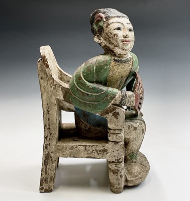 Lot 1039 - A south east Asian carved hardwood figure,...