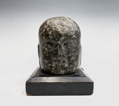 Lot 224 - A Chinese carved stone model of buddhas head,...