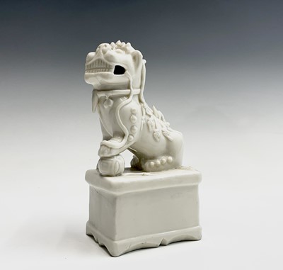 Lot 250 - A Chinese Blanc de Chine figure of a dog of fo,...