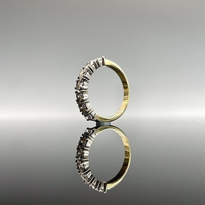 Lot 185 - An 18ct yellow gold ring hoop set with seven...