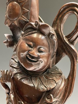 Lot 260 - A Chinese root wood carving of a smiling man...