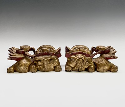 Lot 266 - A pair of Chinese carved giltwood dogs of fo,...