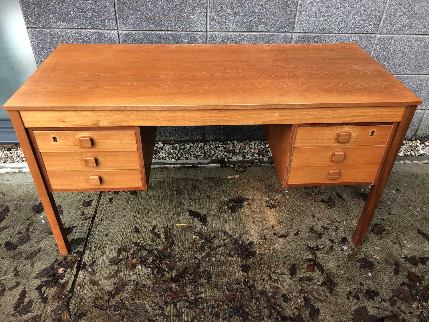 Lot 24 - A mid-century teak desk, height 73cm width 135....