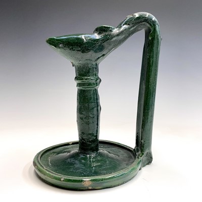 Lot 1004 - An Islamic green glazed pottery oil lamp, 19th...