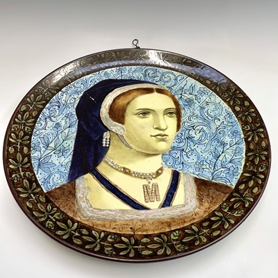 Lot 1077 - A Continental pottery wall plaque, painted in...