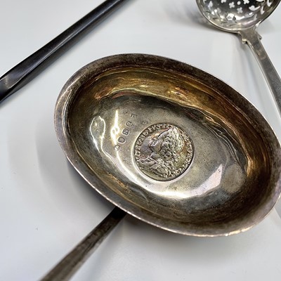 Lot 124 - A George III punch ladle with 1758 sixpence...