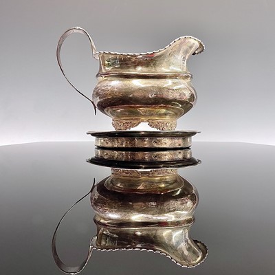 Lot 84 - A plain George III circular silver teapot...