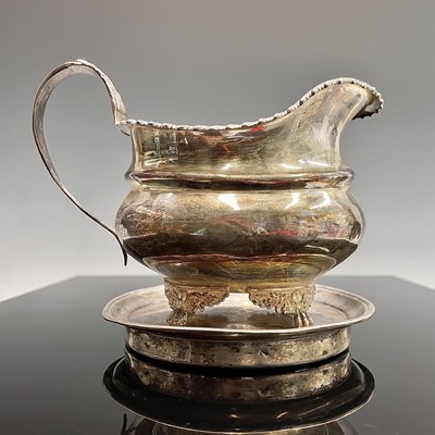 Lot 84 - A plain George III circular silver teapot...