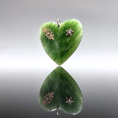 Lot 290 - A New Zealand greenstone heart pendant with...