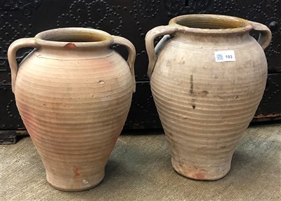 Lot 193 - Two terracotta olive storage jars.