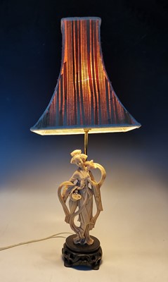 Lot 4 - A vintage carved resin table lamp figure in...