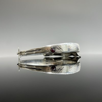 Lot 285 - A high purity silver garfish bangle with ruby...