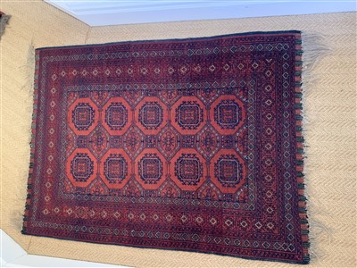 Lot 274 - An Afghan rug with five rows of two octagonal...