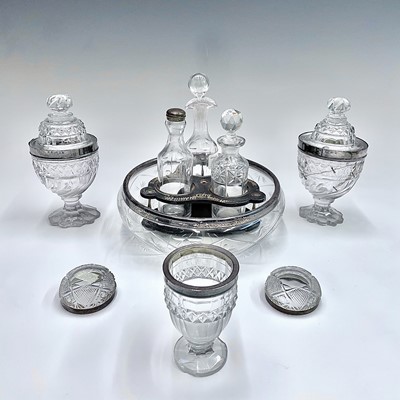 Lot 1034 - A pair of George III cut glass condiment jars...