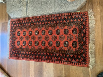 Lot 283 - An Afghan rug with nine rows of two octagonal...