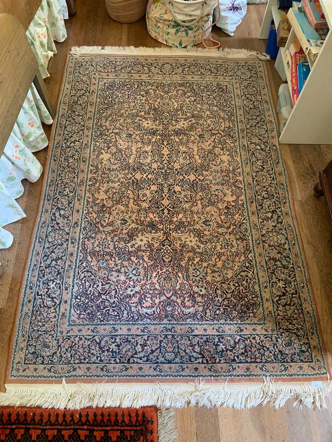 Lot 284 - A Persian Ghom rug, the madder field with a