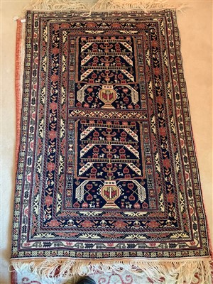 Lot 292 - A Belouch rug, the indigo field with two...