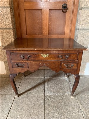 Lot 401 - A George III oak lowboy, the rectangular...