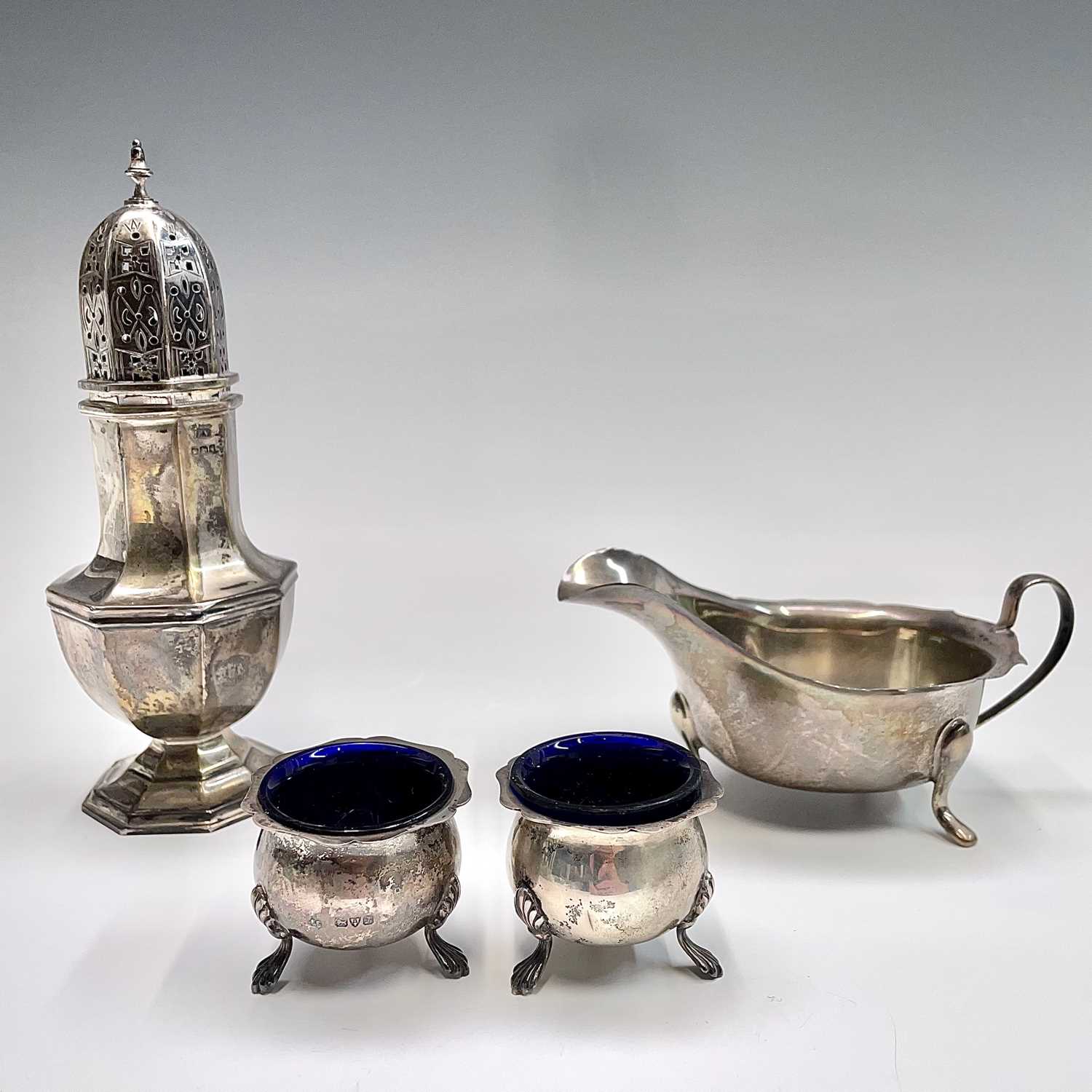 Lot 59 - A silver sugar caster, a silver sauce boat and...