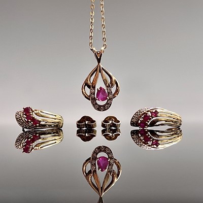 Lot 155 - A 9ct gold pendant set with rubies and...