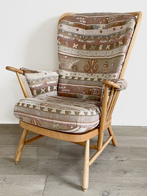 Lot 300 - A modern Ercol beech framed upholstered armchair.