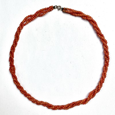Lot 768 - A coral three twisted strand bead necklace...