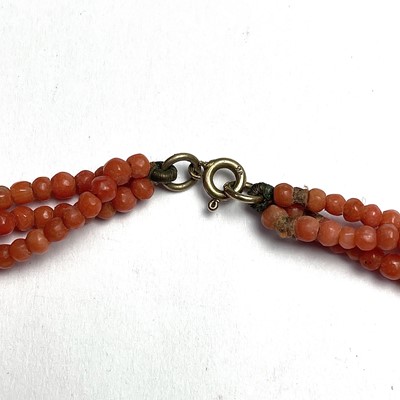 Lot 768 - A coral three twisted strand bead necklace...