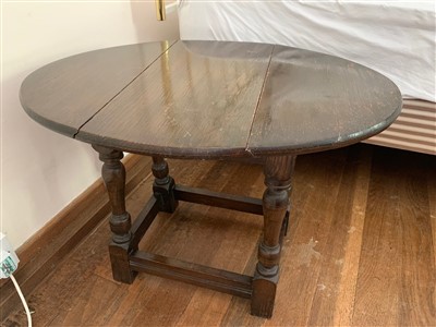 Lot 351 - A 17th century style oak drop leaf table.