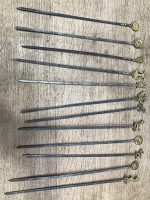Lot 86 - Set of 12 skewers with brass cast finials,...