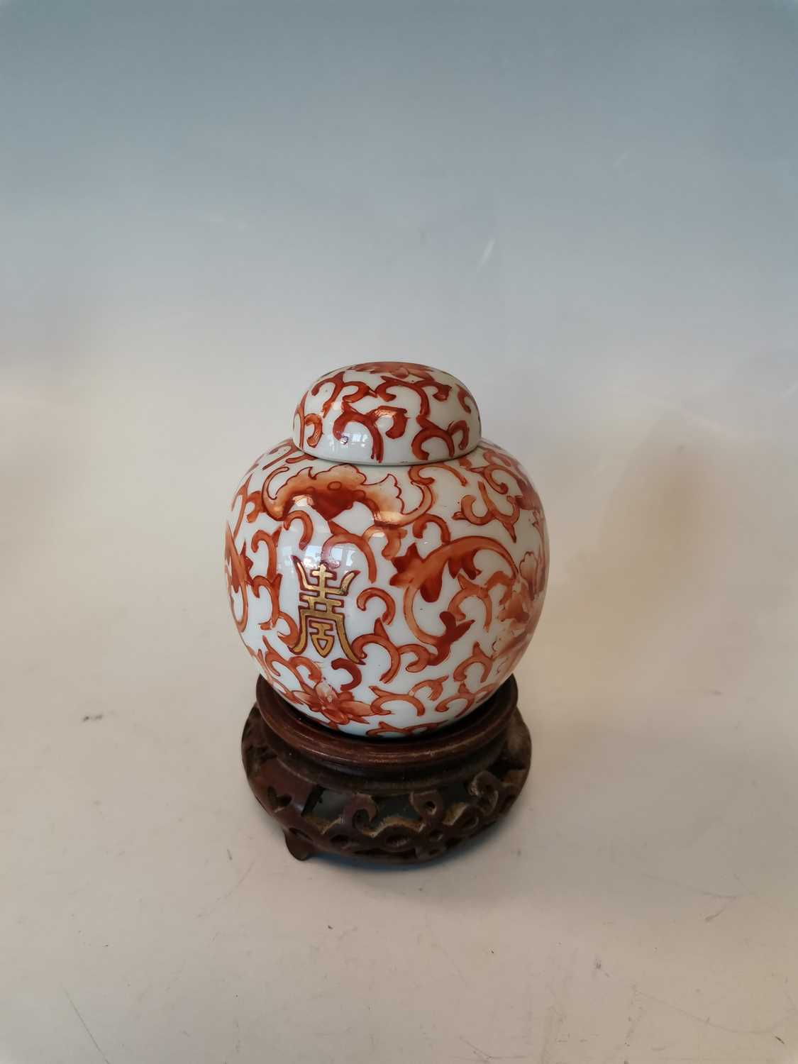 Lot 19 - A Chinese porcelain ginger jar on a wooden...