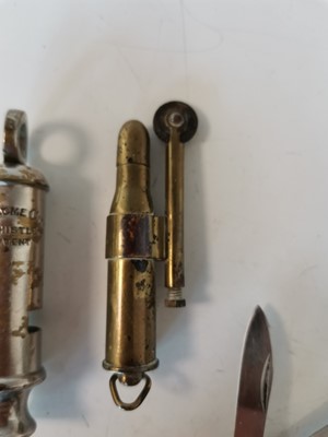 Lot 29 - A brass trench art cigarette lighter, an Acme...