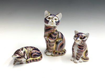 Lot 1152 - Three Royal Crown Derby cat ornaments, each...