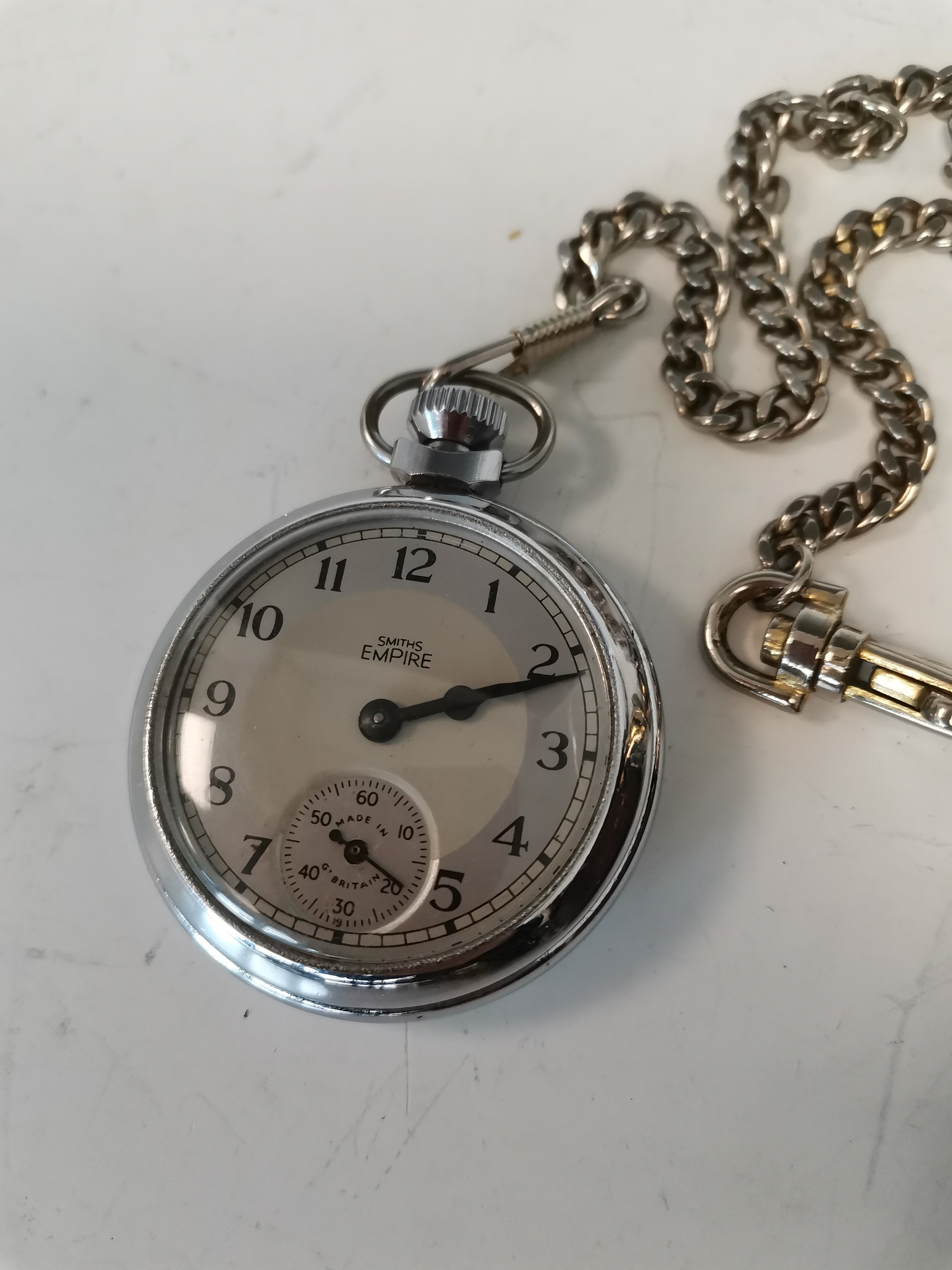Lot 17 A Smiths Empire pocket watch, with chain and