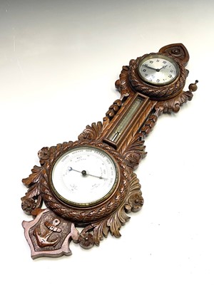 Lot 2905 - A late Victorian walnut clock/barometer, with...