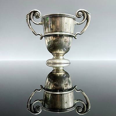 Lot 13 - An Edwardian silver small pedestal trophy cup...
