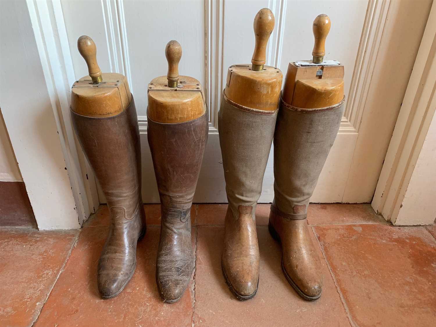 Lot 1 - Two pairs of leather riding boots, with wooden...