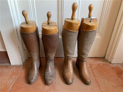 Lot 1 - Two pairs of leather riding boots, with wooden...