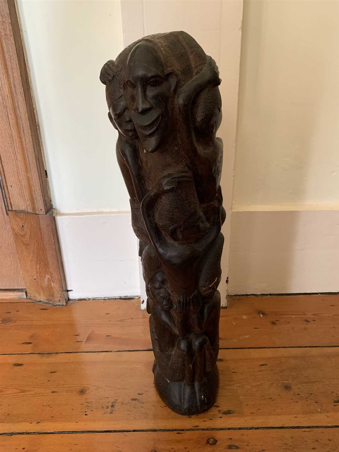 Lot 60 - An African carved wood figural group.