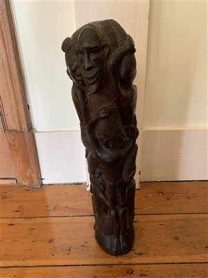 Lot 60 - An African carved wood figural group.