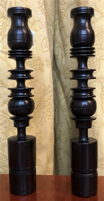 Lot 49 - A pair of turned treen candlesticks.
