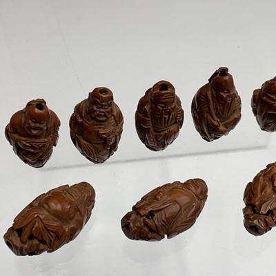 Lot 122 - Eight Chinese carved coquilla nuts, each in...