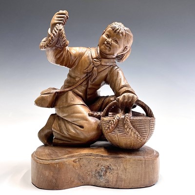 Lot 128 - A Chinese carved wood figure of a kneeling...